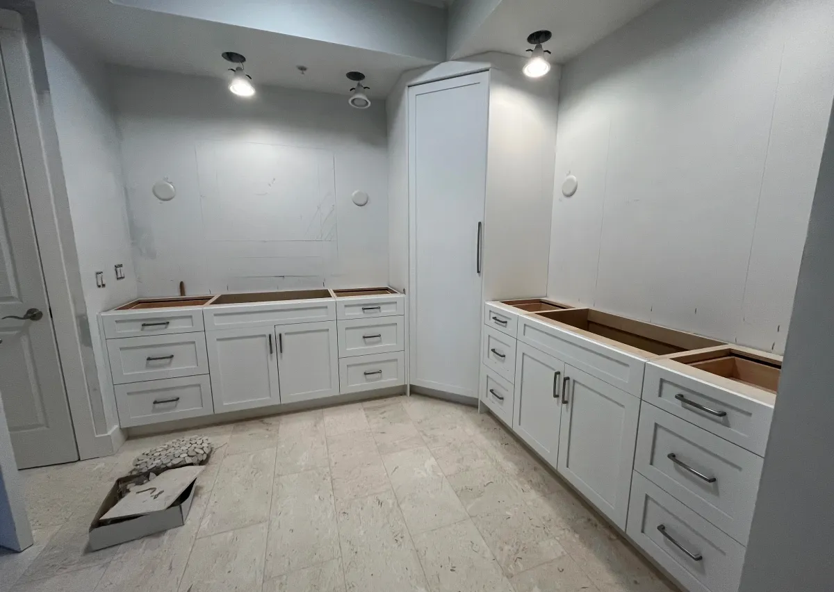 EG Custom Cabinets Luxurious custom walk-in closet with premium cabinetry by EG Contractors in Naples, FL